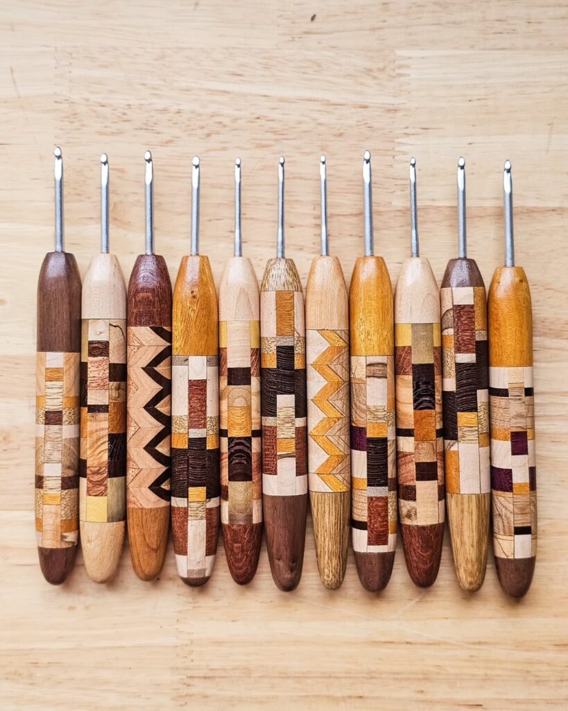 11 handmade wooden crochet hooks, each hook has a different wood design 