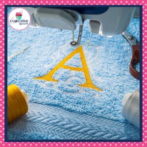 A yellow letter "A" is machine embroidered on a towel.